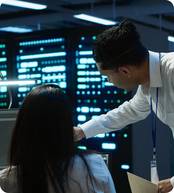 Man and lady discussing in front of computer in server room